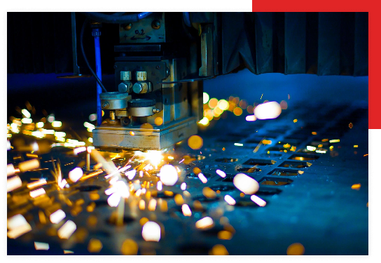 A machine cutting metal with sparks flying from it.